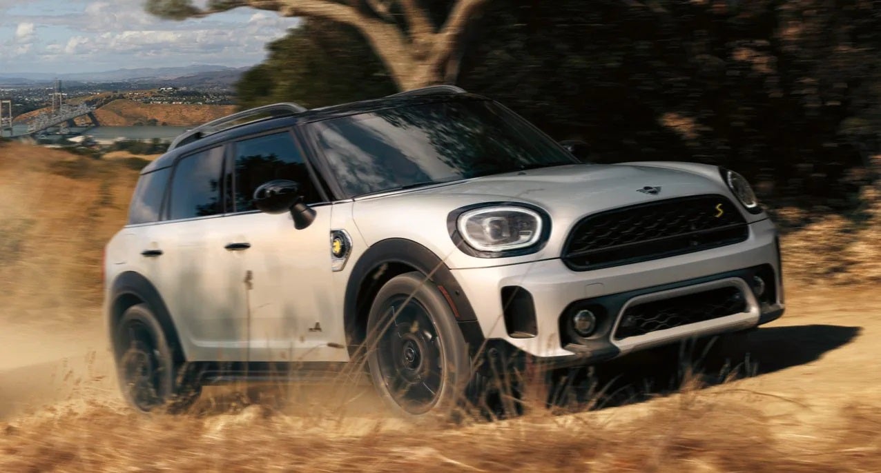 The MINI Cooper SE Countryman PHEV driving on dirt terrain. Flow MINI of Raleigh in Raleigh NC