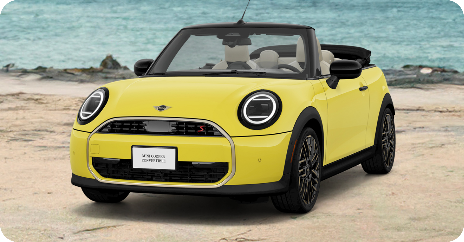 Front view of yellow MINI Cooper Convertible parked on the beach.